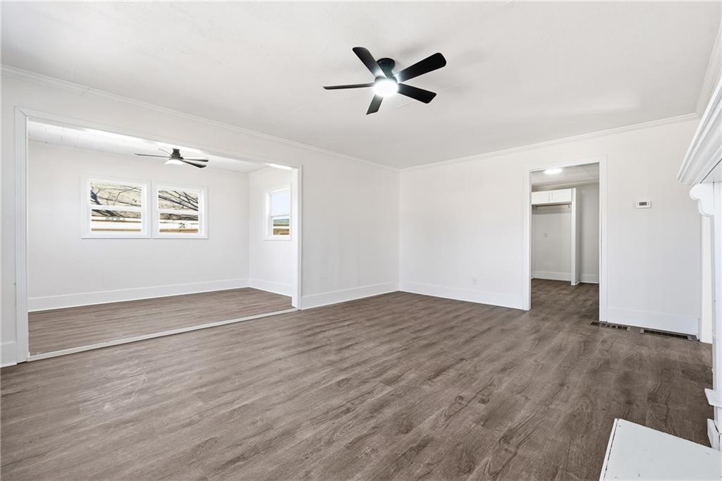 34 Wade Street Winder, GA 30680 - Photo 3 of 22 a view of empty room with wooden floor and ceiling fan