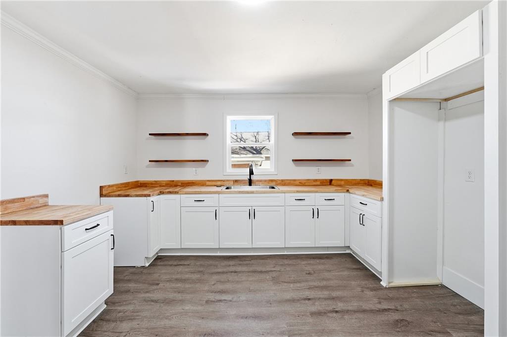 34 Wade Street Winder, GA 30680 - Photo 9 of 22 a kitchen with granite countertop a sink and cabinets