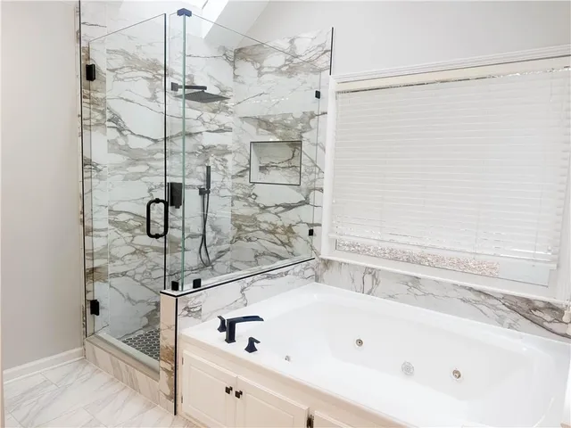 a bathroom with a bathtub and a shower