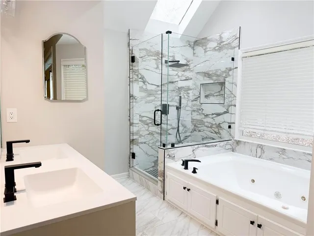 a bathroom with a bathtub and shower