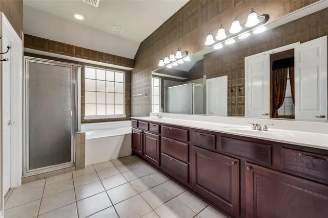 a large bathroom with a large tub and sink