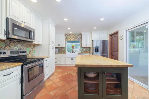 a kitchen with stainless steel appliances granite countertop a stove and a microwave