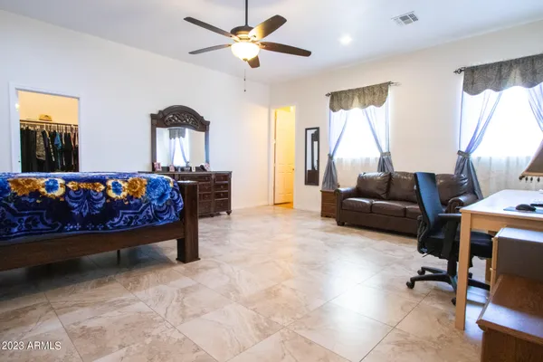 a living room with furniture dining table wooden floor and a fireplace