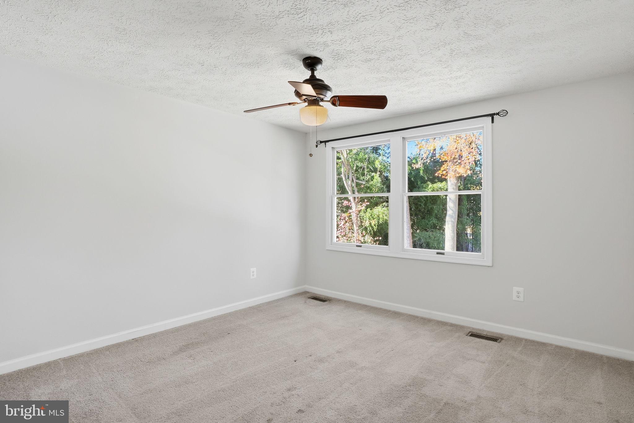474 Ruffian Court Annapolis, MD 21409 - Photo 13 of 36 an empty room with wooden floor ceiling fan and window
