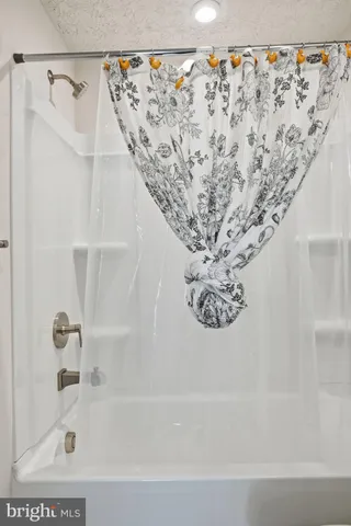 a bathroom with a double vanity sink toilet and a mirror