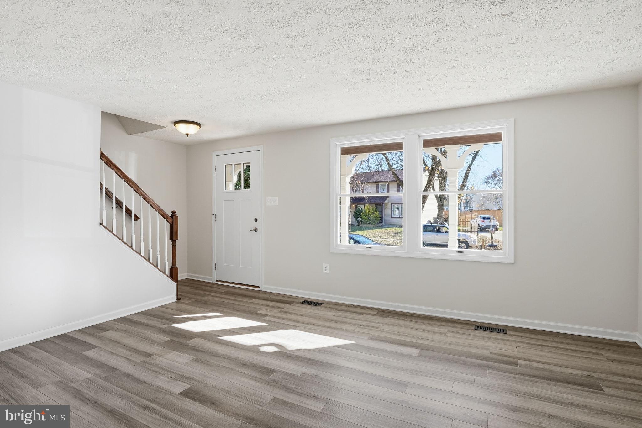 474 Ruffian Court Annapolis, MD 21409 - Photo 2 of 36 a view of an empty room with wooden floor and a window