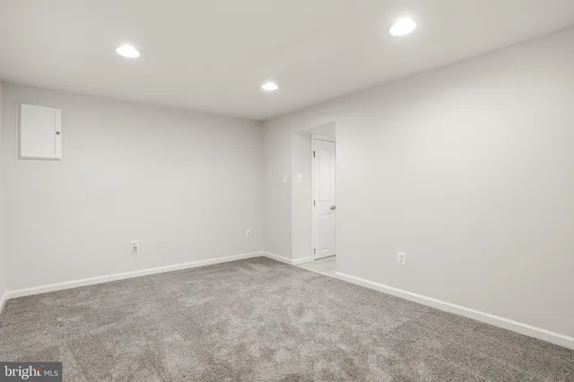 a view of a room with a chandelier fan