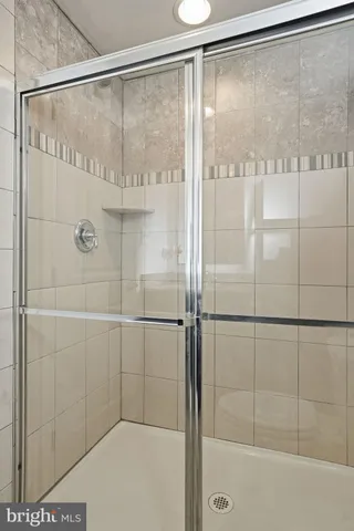a bathroom with a glass shower door