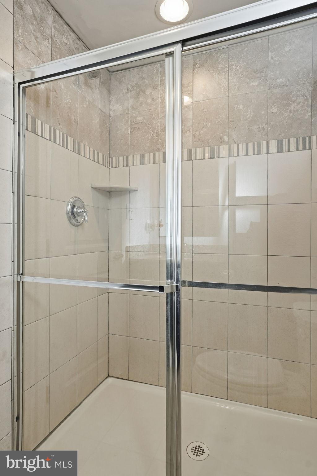 474 Ruffian Court Annapolis, MD 21409 - Photo 25 of 36 a bathroom with a glass shower door