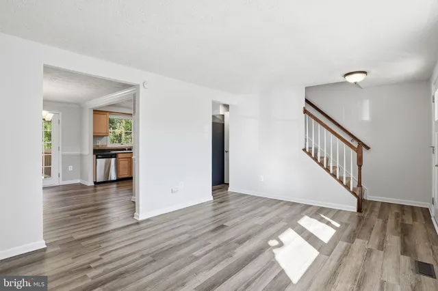 a view of interior space with wooden floor and stairs