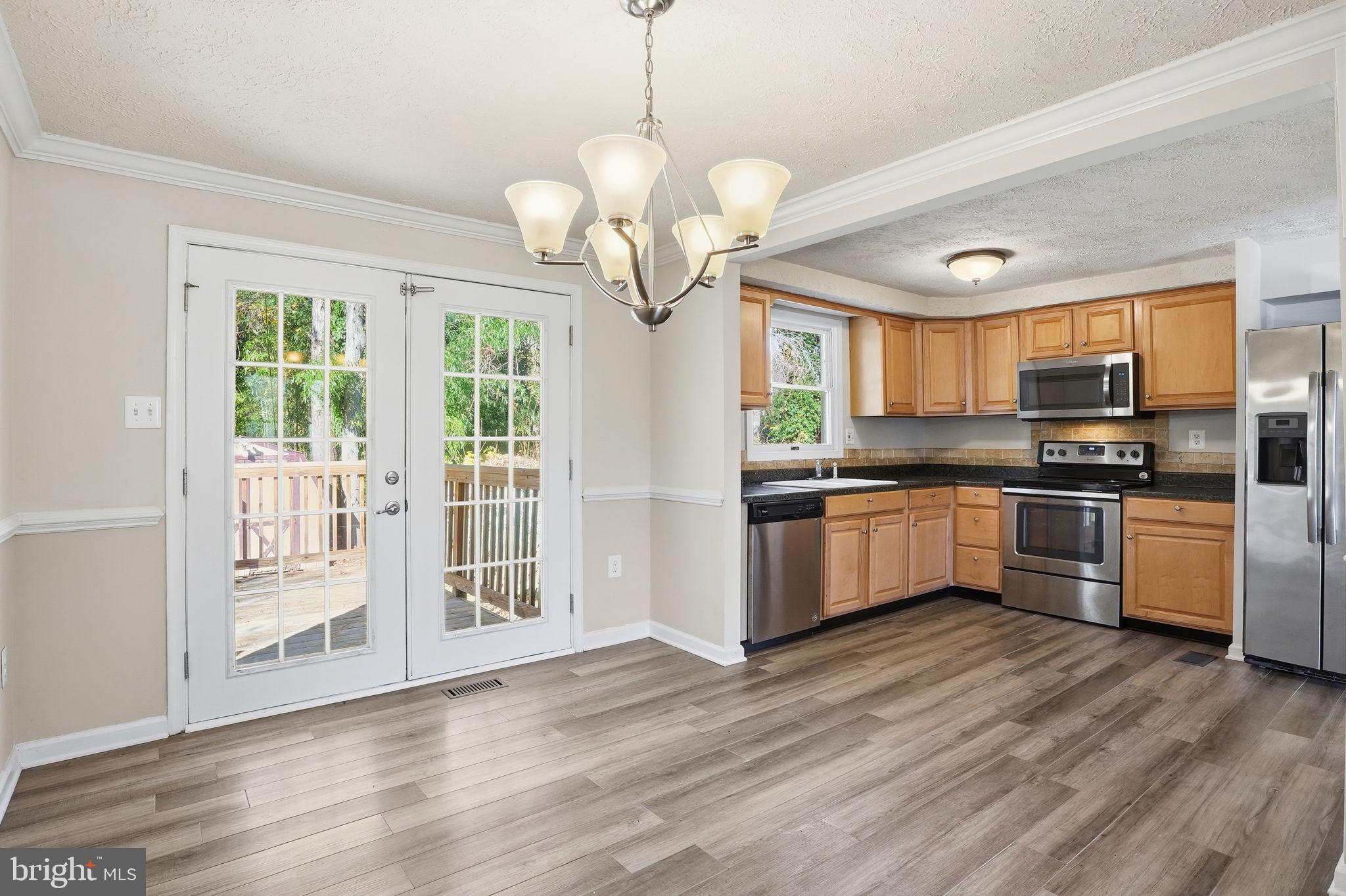 474 Ruffian Court Annapolis, MD 21409 - Photo 9 of 36 a kitchen with a refrigerator cabinets and wooden floor