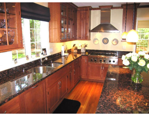 41 Woodcliffe Road Lexington, MA 02421 - Photo 11 of 26 a kitchen with stainless steel appliances granite countertop a stove a sink and a granite counter tops with wooden floors