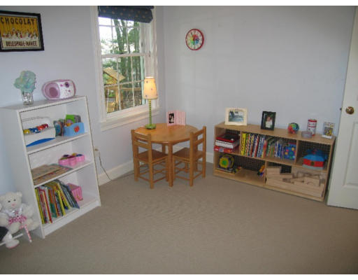 41 Woodcliffe Road Lexington, MA 02421 - Photo 19 of 26 a room with furniture a baby crib and a book shelf