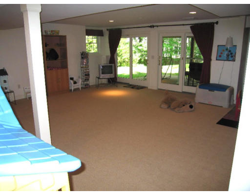 41 Woodcliffe Road Lexington, MA 02421 - Photo 25 of 26 a view of an empty room with a fireplace and a large window