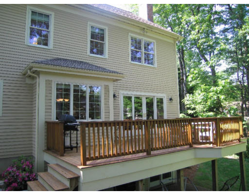 41 Woodcliffe Road Lexington, MA 02421 - Photo 3 of 26 a view of a house with a small yard and wooden fence