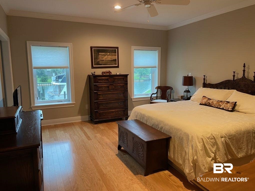 6426 East Quarry Drive Elberta, AL 36530 - Photo 8 of 19 Bedroom featuring ceiling fan, crown molding, and light hardwood / wood-style flooring