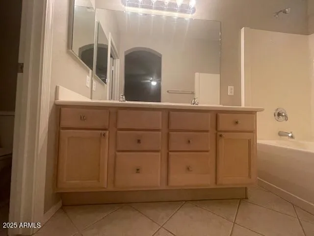 a view of cabinets and utility room with mirror