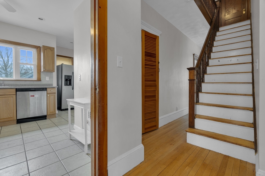 64 Commonwealth Road Watertown, MA 02472 - Photo 19 of 23 a view of a hallway with wooden floor and staircase