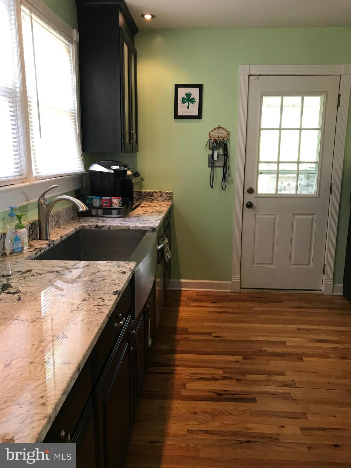 204 West Glebe Road Alexandria, VA 22305 - Photo 2 of 26 a kitchen with granite countertop a sink stove and cabinets