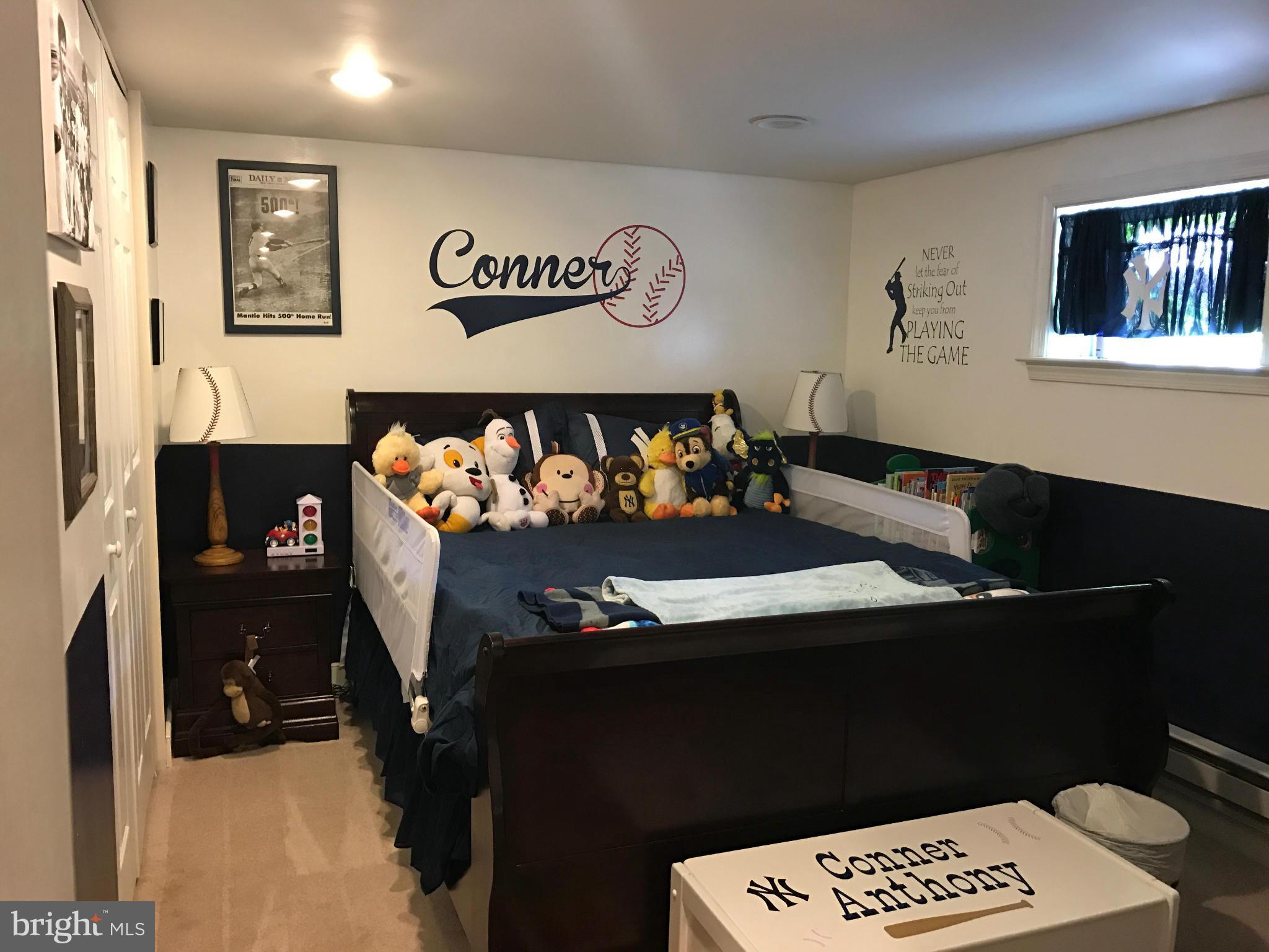 204 West Glebe Road Alexandria, VA 22305 - Photo 13 of 26 a bed sitting in a bedroom next to a window with tv