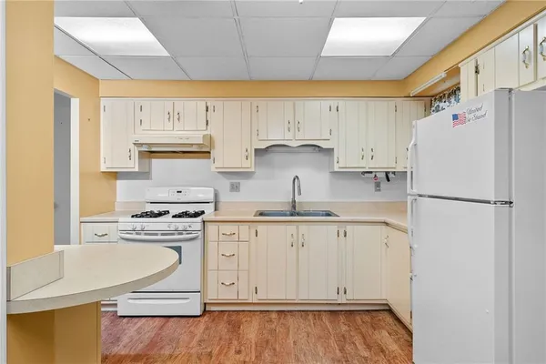 a kitchen with stainless steel appliances granite countertop a refrigerator sink and stove