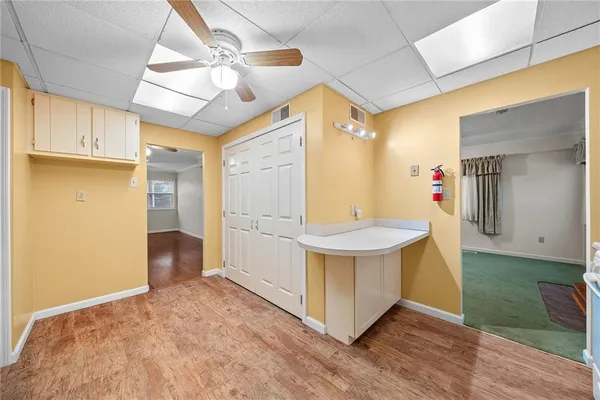 a view of kitchen with furniture and wooden floor