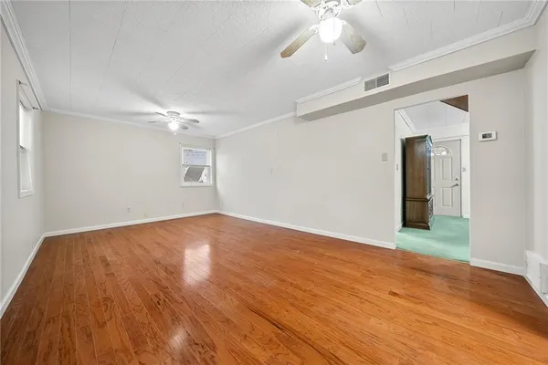 wooden floor in an empty room with a window