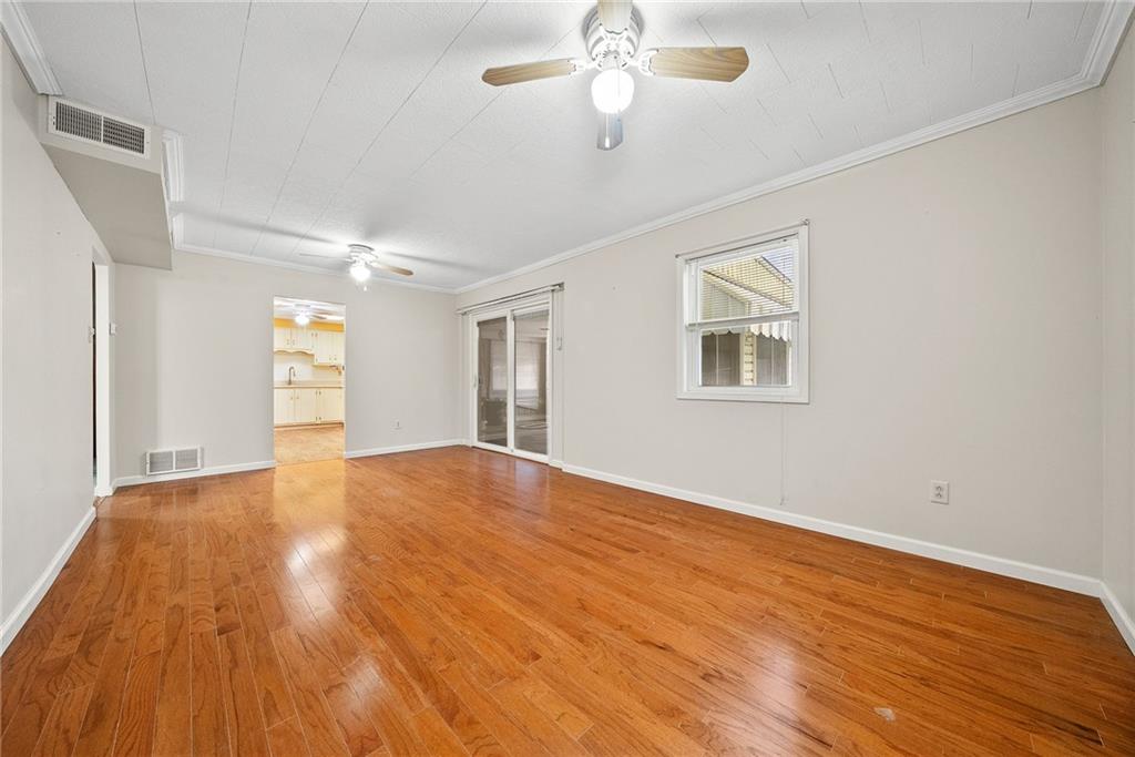 185 Walnut Street Beaver, PA 15009 - Photo 17 of 43 a view of empty room with wooden floor and fan