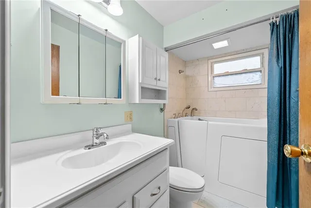 a bathroom with a sink toilet and mirror