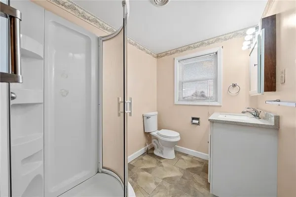 a bathroom with a toilet sink a shower and a mirror