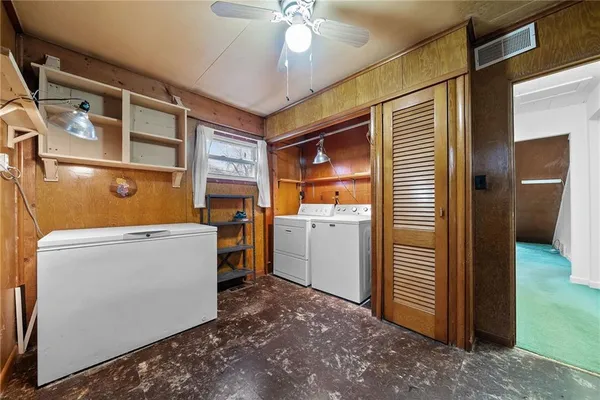 a view of storage and utility room with washer and dryer