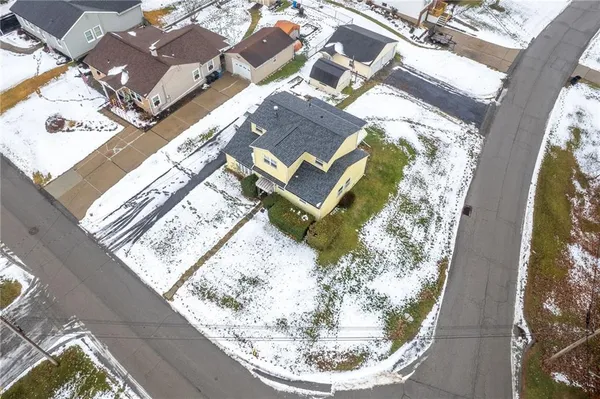 an aerial view of a house with a swimming pool