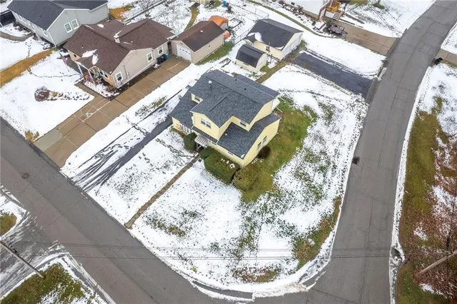 an aerial view of a house with a swimming pool