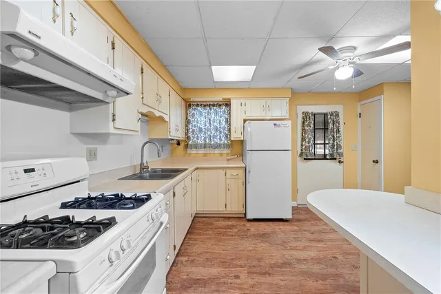 a kitchen with a stove a refrigerator and a sink