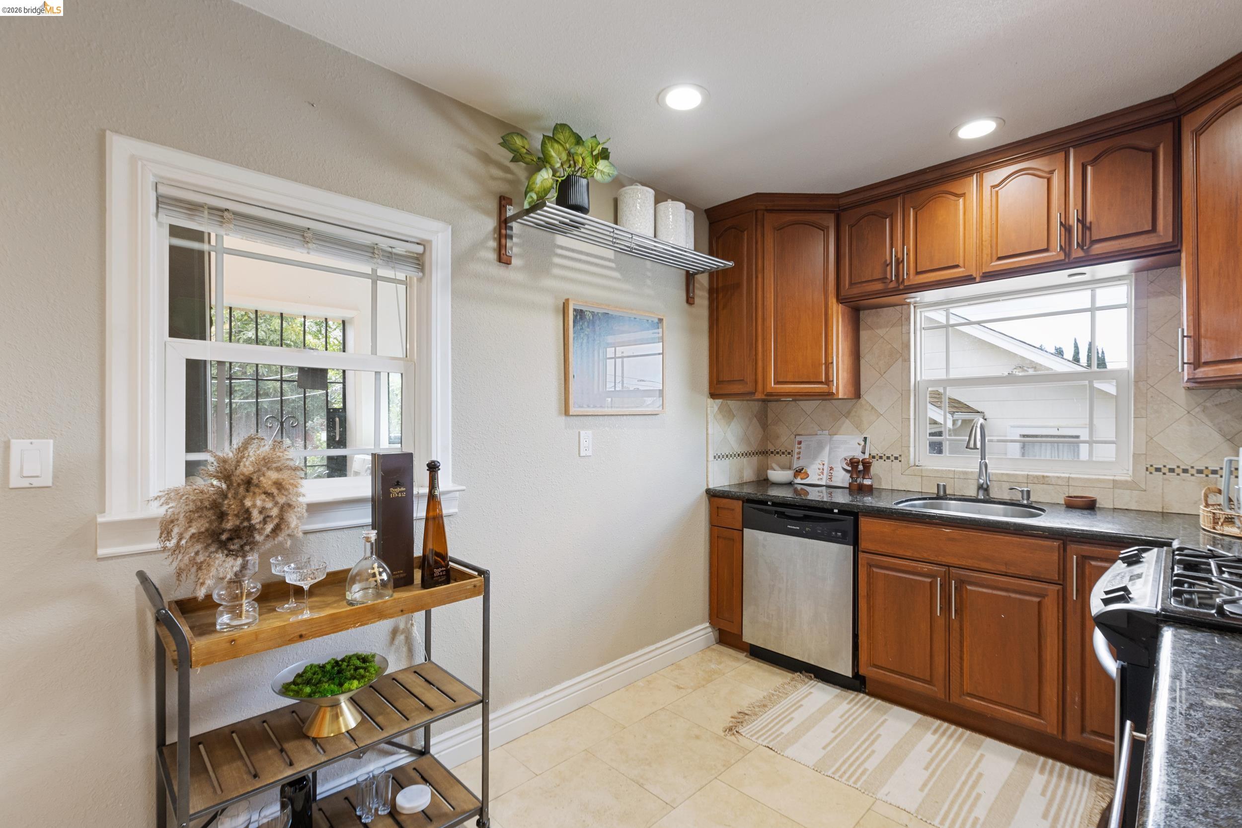 2316 Ransom Avenue Oakland, CA 94601 - Photo 14 of 37 a kitchen with granite countertop a sink stove and cabinets