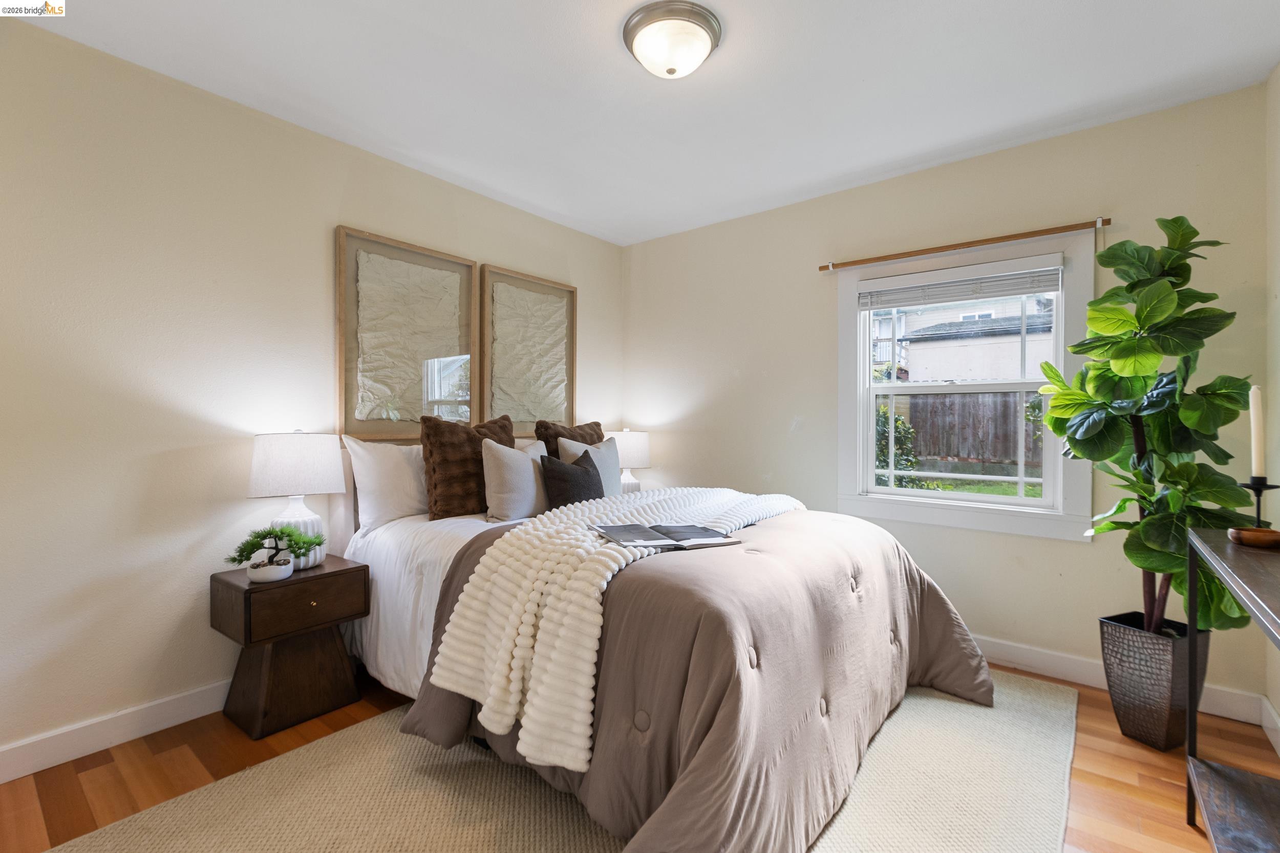 2316 Ransom Avenue Oakland, CA 94601 - Photo 20 of 37 a bed room with a bed and a potted plant