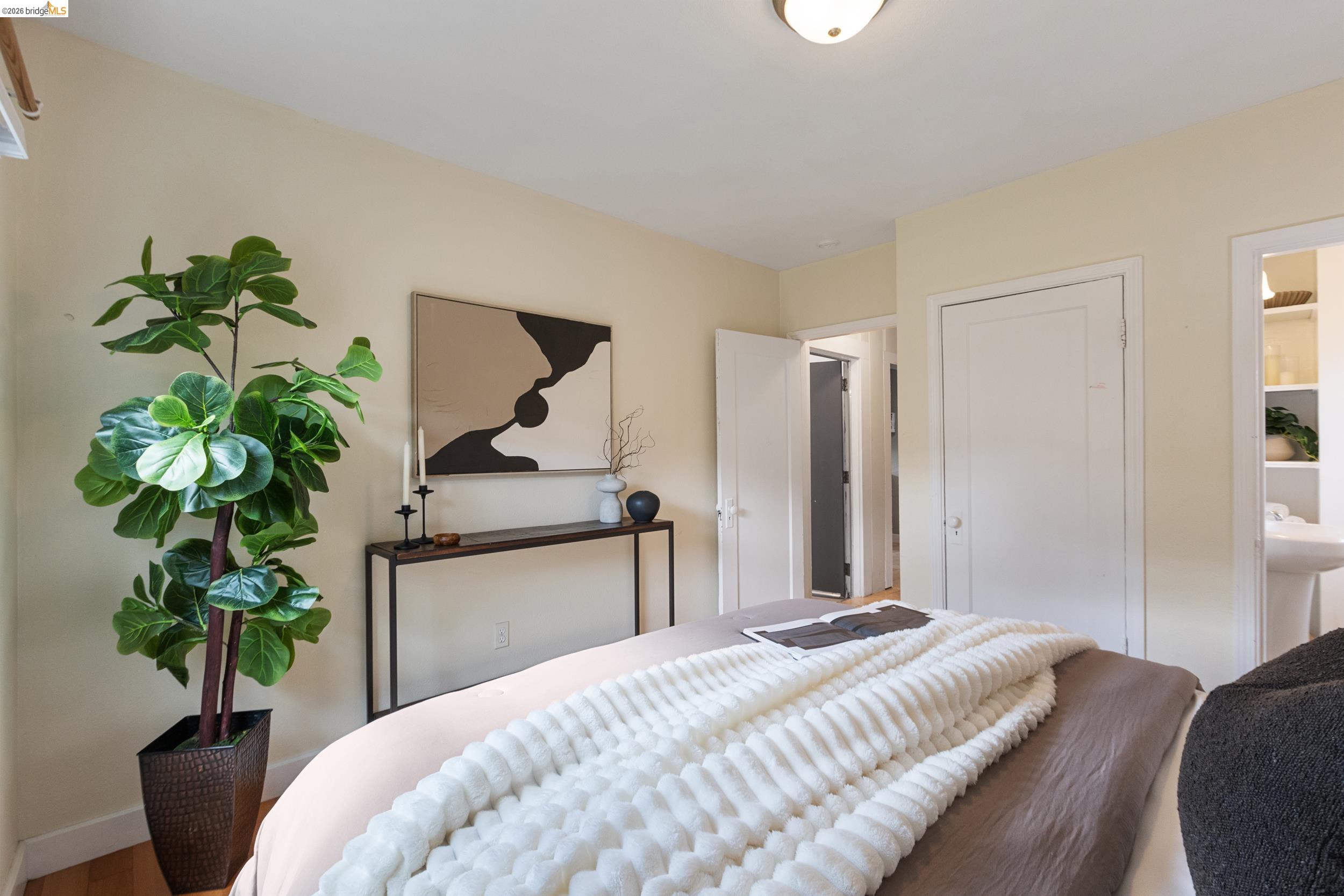 2316 Ransom Avenue Oakland, CA 94601 - Photo 21 of 37 a bedroom with a bed and a potted plant