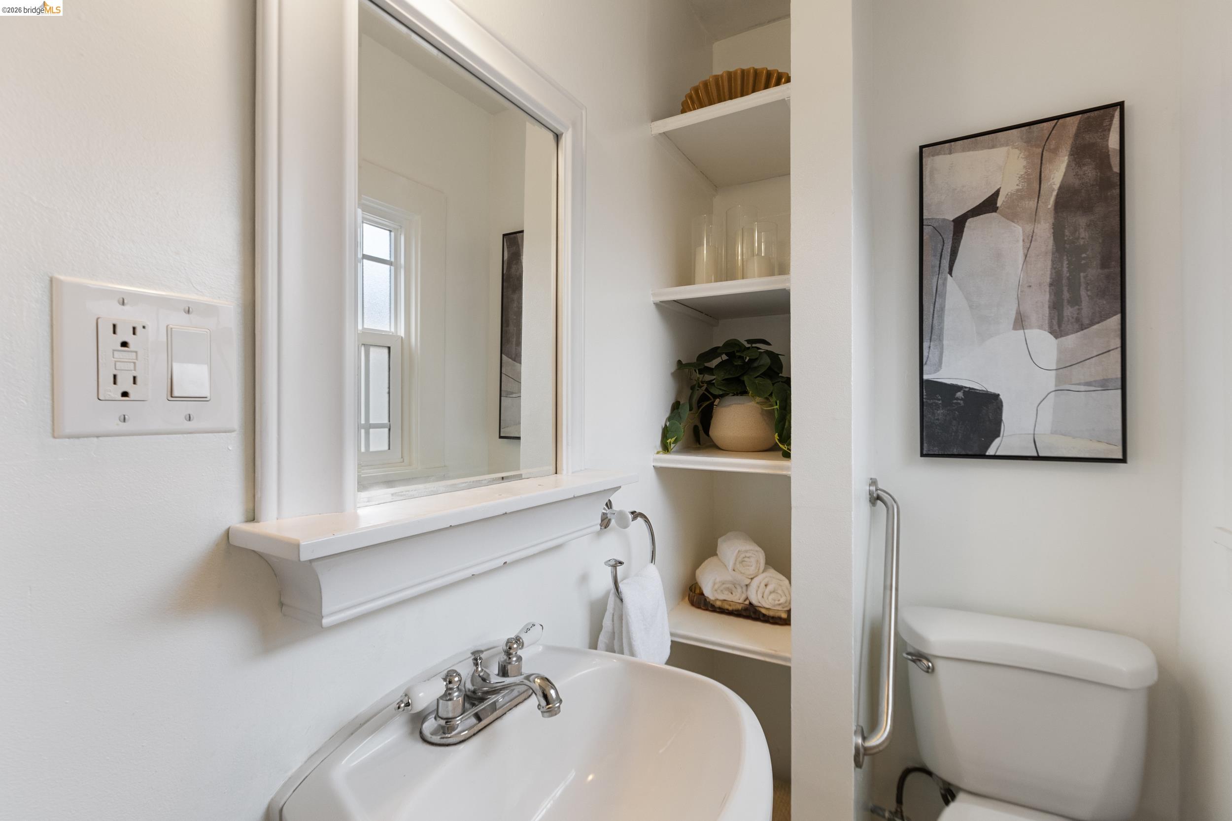 2316 Ransom Avenue Oakland, CA 94601 - Photo 22 of 37 a bathroom with a toilet a sink and mirror