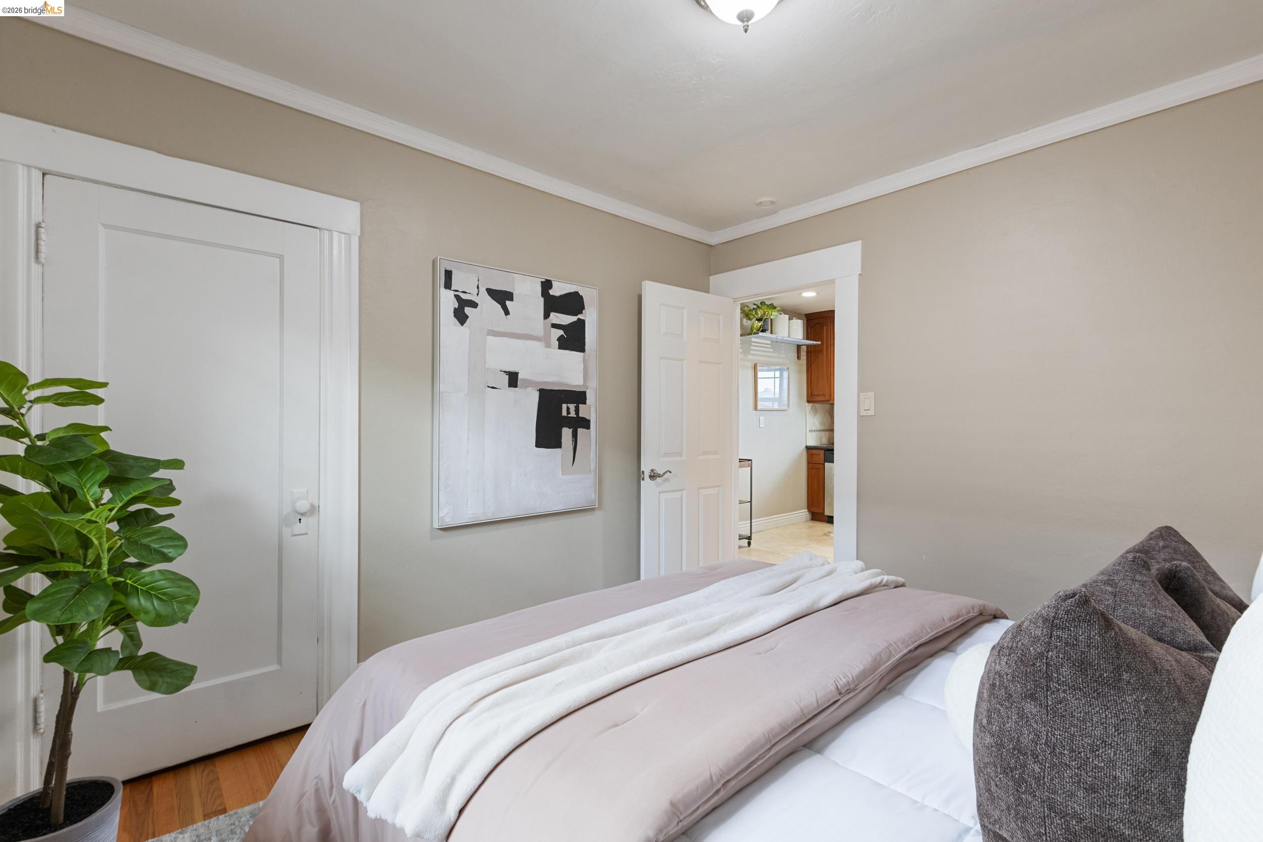 2316 Ransom Avenue Oakland, CA 94601 - Photo 24 of 37 a bedroom with a bed and a potted plant