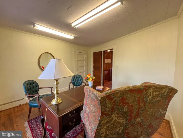 a view of hallway with stairs and wooden floor