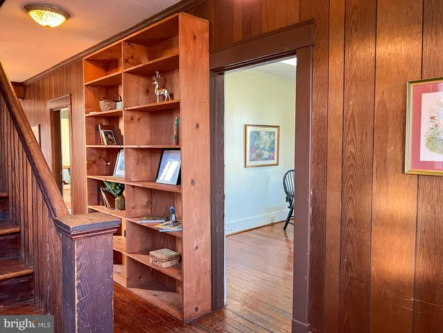 a living room with furniture hardwood floor and a window