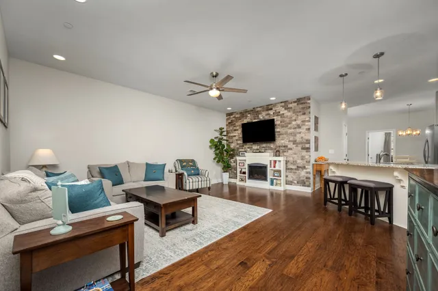 a living room with furniture a fireplace and a flat screen tv