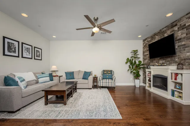 a kitchen with stainless steel appliances a dining table chairs and wooden floor