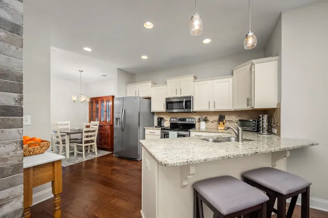 a dining room with furniture and wooden floor