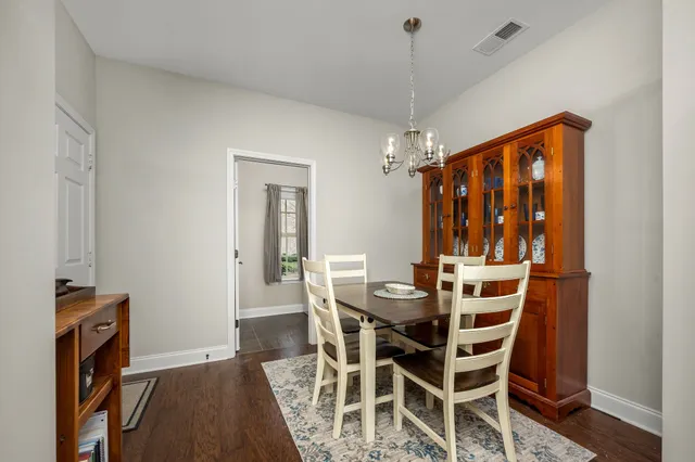 a bathroom with a granite countertop toilet a sink and a mirror