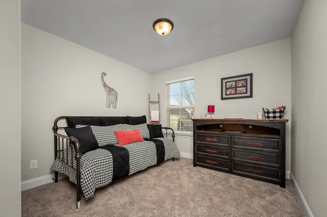 a bedroom with furniture and a ceiling fan