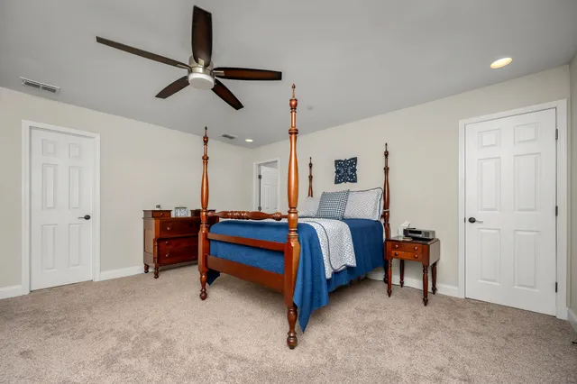 a view of a big house with a yard and plants