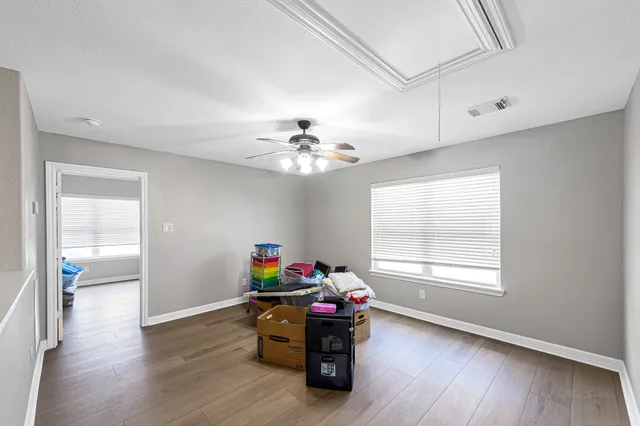 a dining room with furniture a chandelier and wooden floor