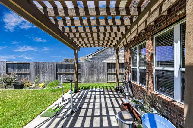 a front view of a house with swimming pool and garden