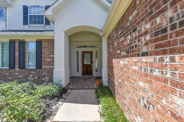a view of a brick house with a large windows